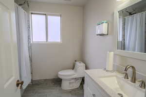 Full bath with vanity and curtained shower