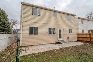 Rear view of property with a patio area, a fenced backyard, and entry steps