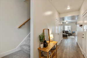 Hallway featuring stairs and light wood finished floors