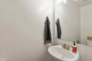 Half bathroom featuring a sink