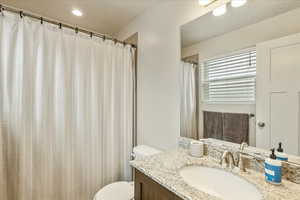 Full bath with vanity and curtained shower