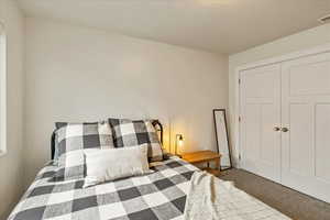 Bedroom featuring carpet floors and a closet