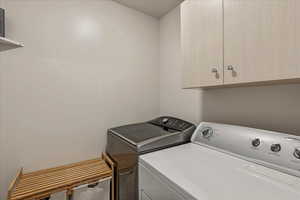 Laundry room with cabinet space and washer and dryer