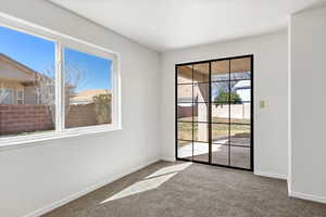 Spare room with a textured wall and carpet floors