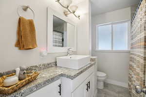 Full bathroom featuring vanity and curtained shower