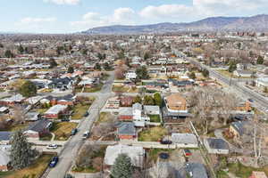 Aerial view of property's location with mountains and nearby suburban area