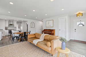 Living area with light wood-style flooring and recessed lighting