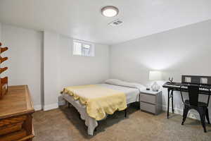 Bedroom with dark carpet and baseboards