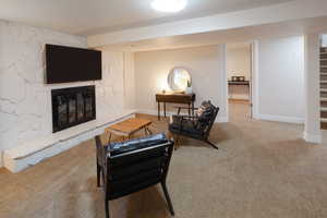 Living room featuring a fireplace and light colored carpet