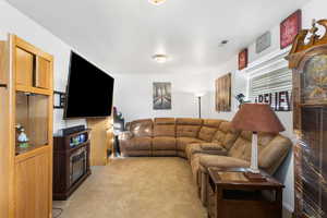 Living room featuring light colored carpet