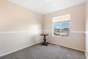 Carpeted spare room with baseboards