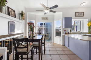 Dining room with a ceiling fan and light tile patterned floors