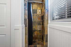 Full bathroom with a shower stall
