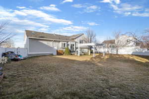 Rear view of property featuring a fenced backyard and a pergola