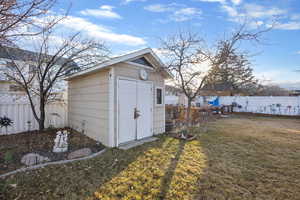 View of shed featuring a fenced backyard