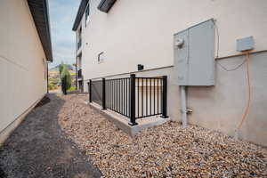 View of property exterior featuring stucco siding and a gate