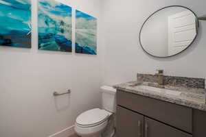 Half bath with vanity and toilet