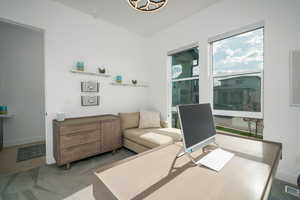 Home office with carpet and baseboards