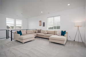Living room with light carpet and recessed lighting