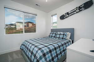 Bedroom with baseboards and carpet flooring