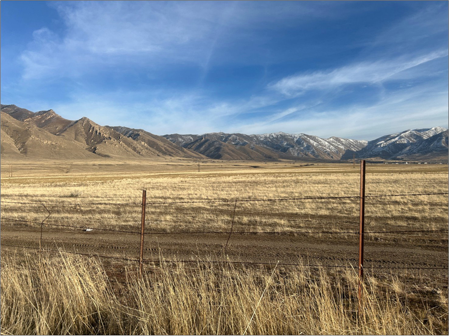 View of mountain backdrop with rural landscape