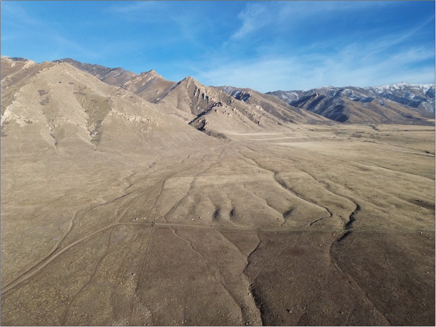 View of mountain backdrop with rural landscape
