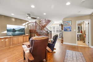 Living area featuring  oakfloors, ceiling fan, and recessed lighting