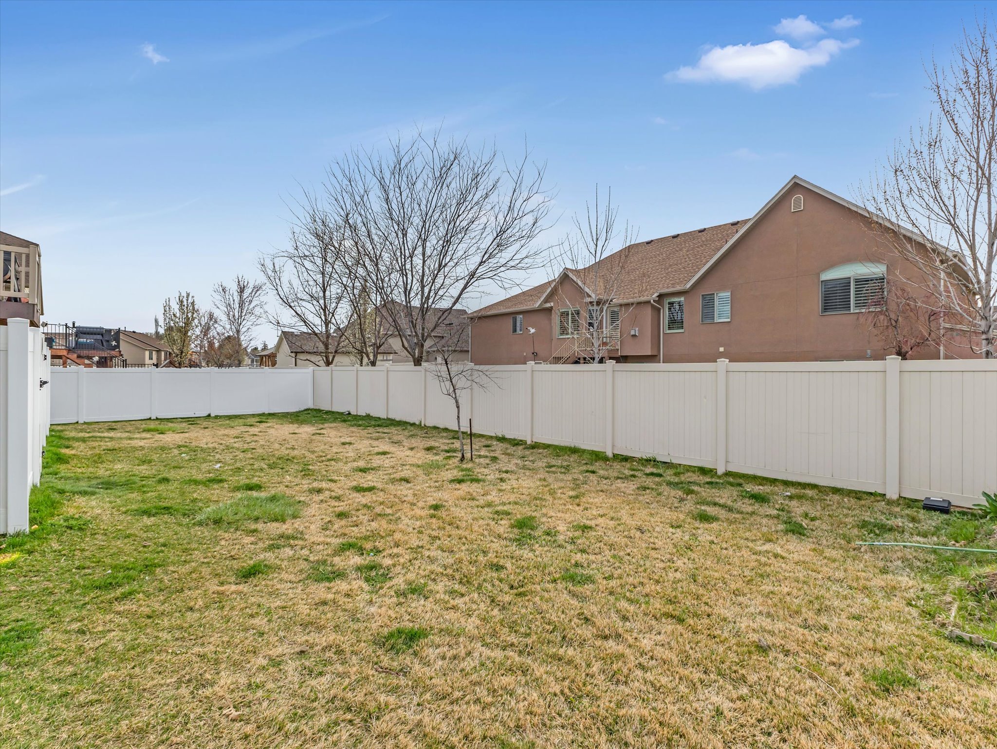 Fenced backyard with a residential view