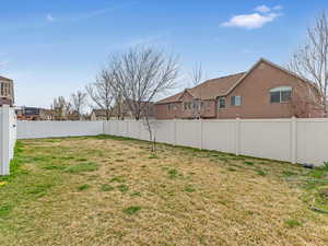 Fenced backyard with a residential view