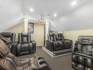 Carpeted home theater room with ornate columns, a ceiling fan, and recessed lighting