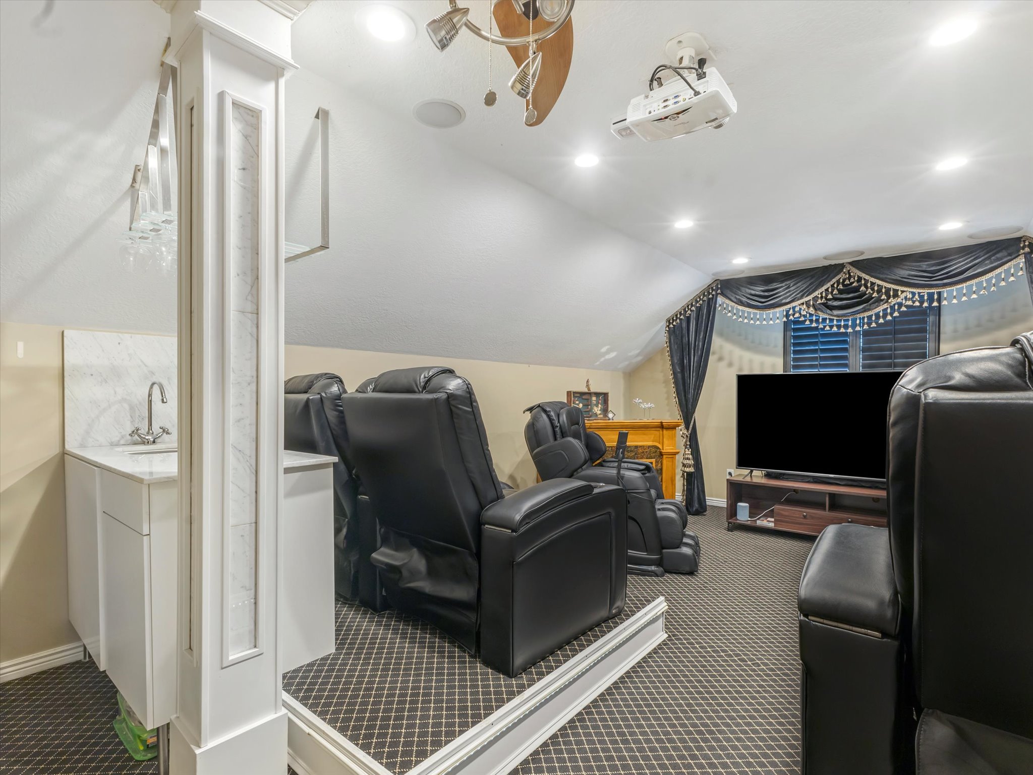 Cinema with dark colored carpet, vaulted ceiling, and recessed lighting