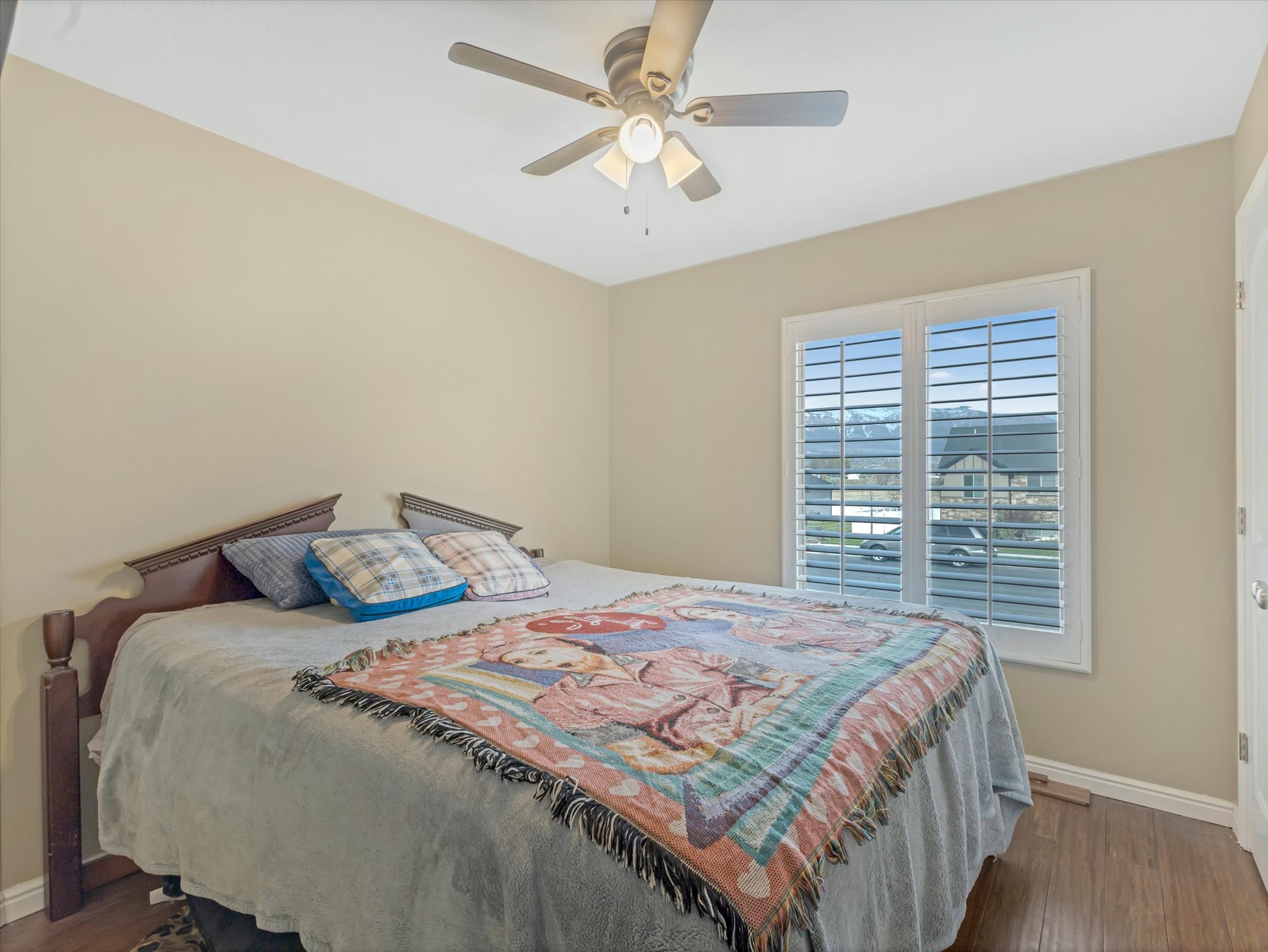 Bedroom with dark wood-style floors and ceiling fan