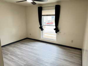 Empty room with light wood finished floors and ceiling fan