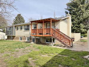 Back of property featuring a wooden deck and a chimney