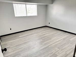 Spare room with light wood finished floors and baseboards