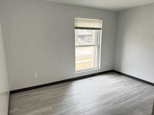 Unfurnished room with light wood-style flooring