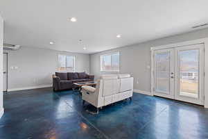 ADU open concept main floor with polished concrete flooring, natural light, and recessed lighting