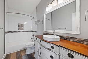 ADU second floor bathroom with spacious vanity, shower / tub combination, and LVP flooring