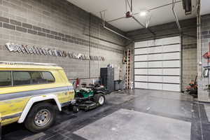 Custom-built shop, heated and fully finished featuring car lift, bar, and bathroom