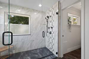 Custom tiled shower with dual shower heads and euro-glass surround