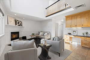 Open concept living space featuring family room and kitchen with workspace