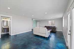 ADU open concept main floor with polished concrete flooring, natural light, and recessed lighting