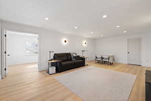 Oversized basement living room featuring LVP flooring and light paint