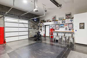 Custom-built shop, heated and fully finished featuring car lift, bar, and bathroom