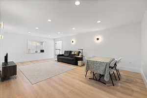 Oversized basement living room featuring LVP flooring and light paint