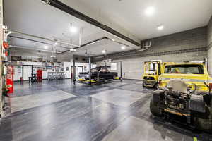 Custom-built shop, heated and fully finished featuring car lift, bar, and bathroom