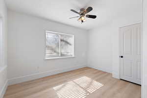 Basement bedroom featuring LVP flooring and light paint