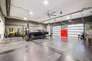 Custom-built shop, heated and fully finished featuring car lift, bar, and bathroom