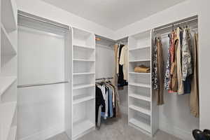 Primary bedroom walk-in closet
