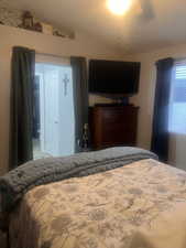 Bedroom featuring lofted ceiling and a ceiling fan